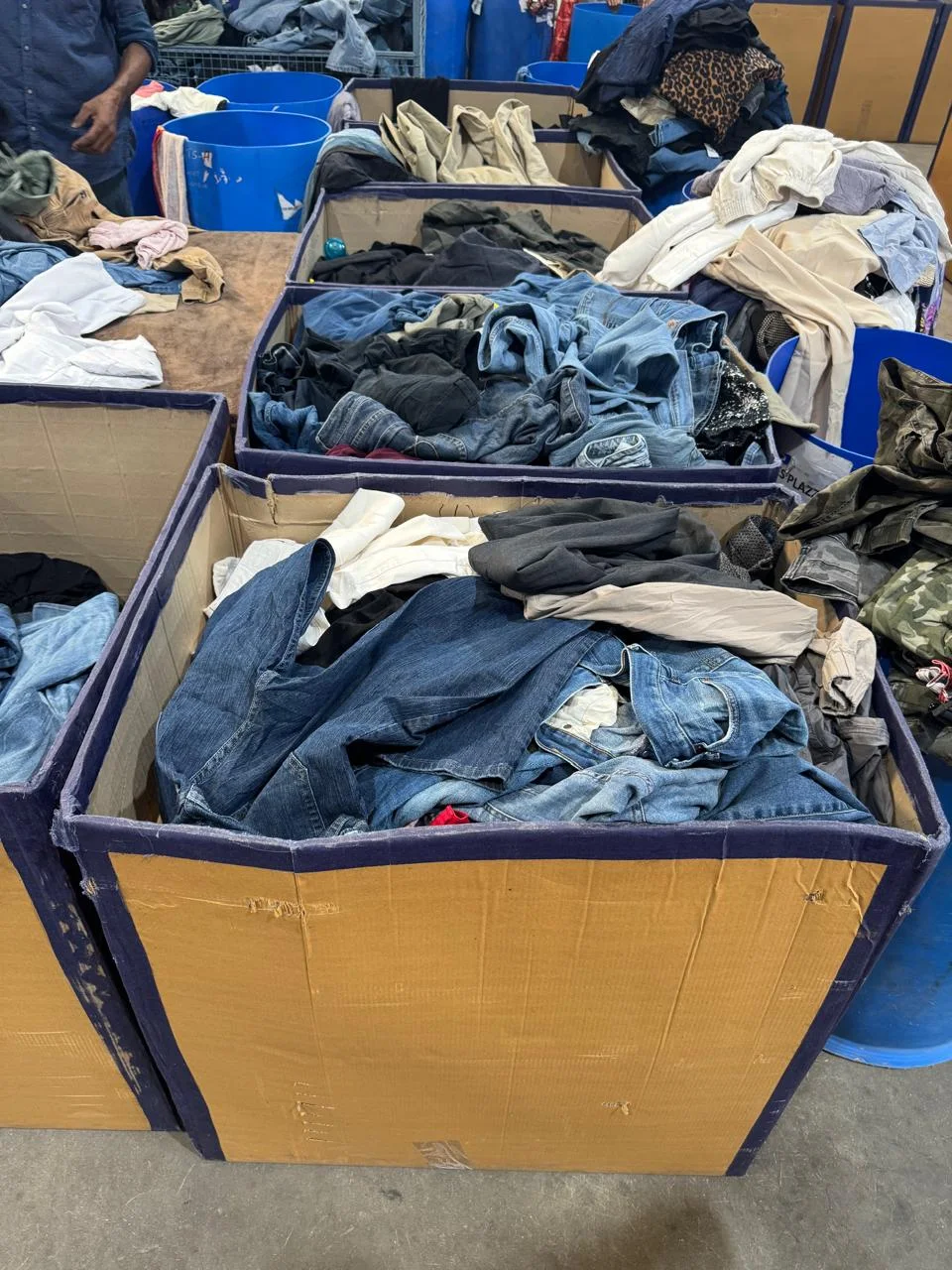 Denim garments separated into sorting bins
