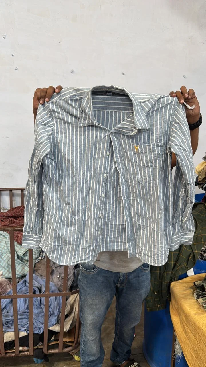 A striped shirt held up for a full front view